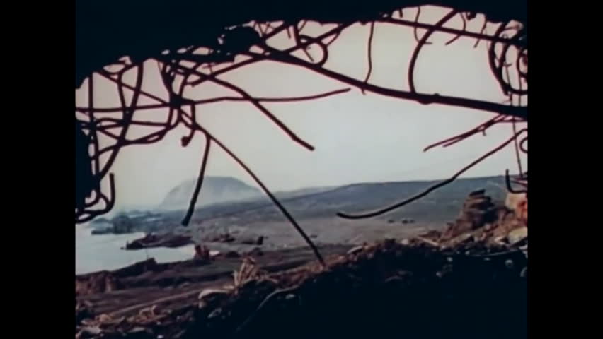 CIRCA 1945 - US Marines use machine guns and grenades to force Japanese soldiers out of caves on Iwo Jima.