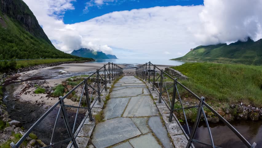 Woman walks on a bridge amid the beautiful nature of Norway. Beautiful Nature Norway natural landscape.