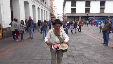 QUITO, ECUADOR - CIRCA 2010s - A one man band musician walks the streets of Quito Ecuador making music.