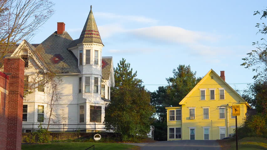 NEW ENGLAND, USA - CIRCA 2010s - Old Victorian houses along a quiet street in New England.