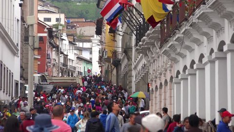 QUITO, ECUADOR - CIRCA 2010s - Very large crowds swarm the streets of downtown Quito Ecuador at siesta time.
