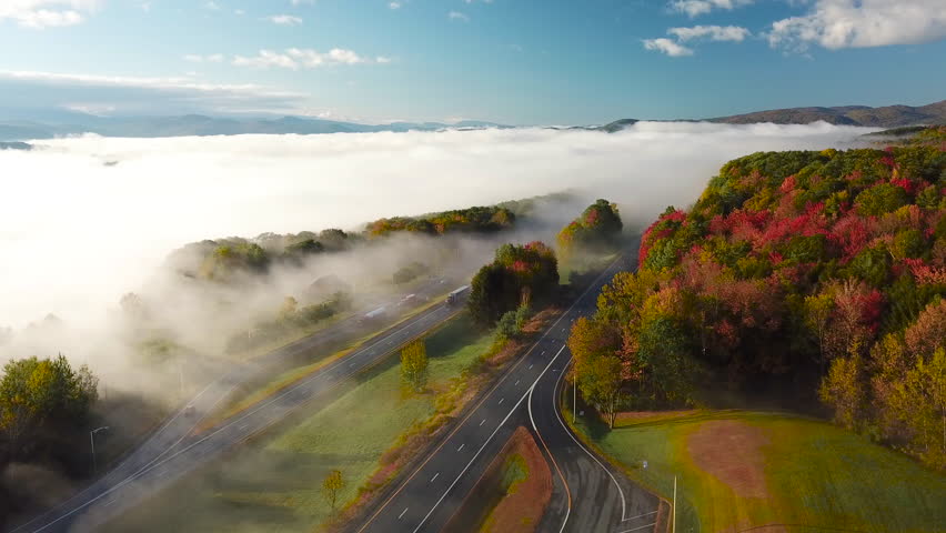 NEW ENGLAND, USA - CIRCA 2010s - Beautiful aerial over a highway through the fog in fall in New England.
