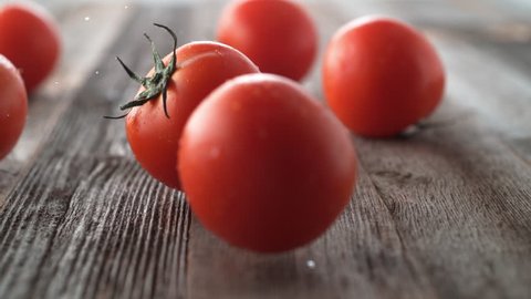 Tomatoes falling and rolling on a table. Shot with high speed camera, phantom flex 4K. Slow Motion.