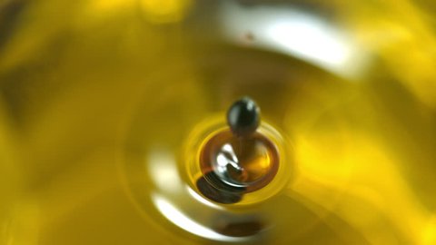 Balsamic vinegar dripping into olive oil. Shot with high speed camera, phantom flex 4K. Slow Motion.