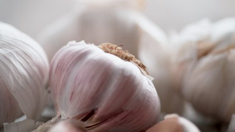 Whole garlic bulbs and garlic skin is blown away. Shot with high speed camera, phantom flex 4K. Slow Motion.