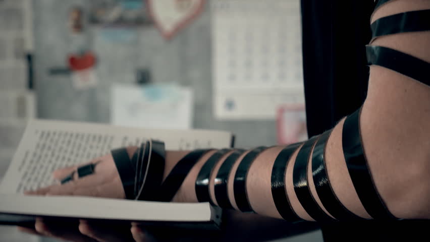 Hand of young jewish man with a tefillin on his arm, holding a psalms book, while reading a pray at a jewish ritual. Royalty-Free Stock Footage #1006718251