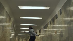Black man dancing hip-hop in an underground crossing