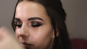 Make-up artist makes make-up an attractive caucasian girl