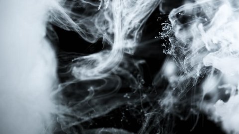 Abstract white ink in water on black background. Dropping white ink in water, shooting with high speed camera 120 fps. 4K Slow motion video