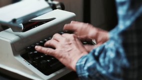 Hands typing a film script or a book on a vintage typewriter, 4k video