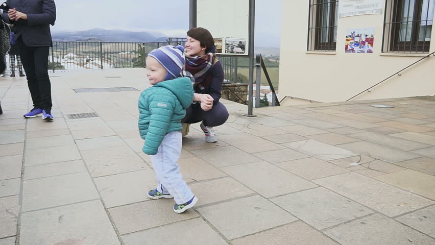 Joyful kid dances and runs in a historical place. shot with stedicam. Spain. Ronda. slow motion