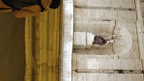 Vertical video. Girl is coming to Fontana della Dea Roma. Night. Rome, Italy
