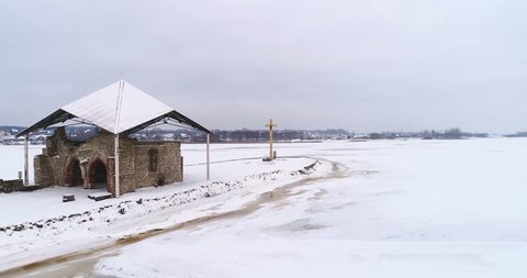 Ruins of old church in the middle of frozen river. Saint Meinards island in river Daugava