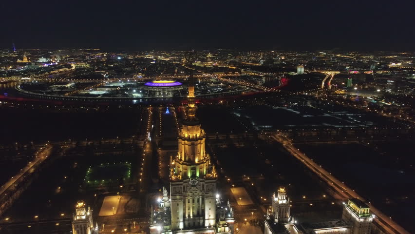 Moscow State University Main Campus and Illuminated Moscow Skyline at Clear Winter Night. Spire closeup. Russia. Aerial View. 