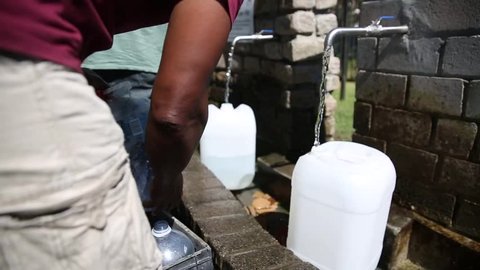 Cape Town / South Africa - January 25, 2018: People filling up natural spring water for drinking in Newlands in the drought in Cape Town South Africa