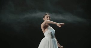 4K video footage beautiful Asian girl ballet dancer dancing on black background slow motion