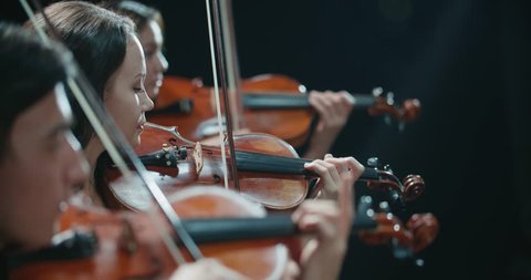 string quartet performs on stage, close-up of violin in work