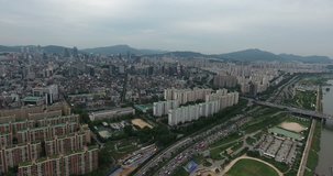 SEOUL, SOUTH KOREA – JULY 216 : Aerial shot over Han River on a cloudy day with traffic and cityscape in view