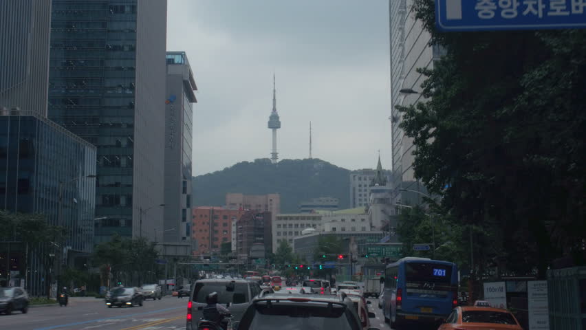 SEOUL, SOUTH KOREA – JULY 216 : Video shot of city centre traffic at daytime with cars, tall buildings and N Seoul Tower in view