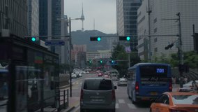 SEOUL, SOUTH KOREA – JULY 216 : Video shot of city centre traffic at daytime with cars, tall buildings and N Seoul Tower in view