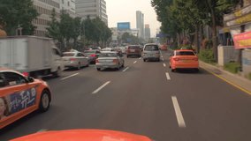 SEOUL, SOUTH KOREA – JULY 216 : Video shot of central Seoul traffic on a sunny day with cars and skyline in view