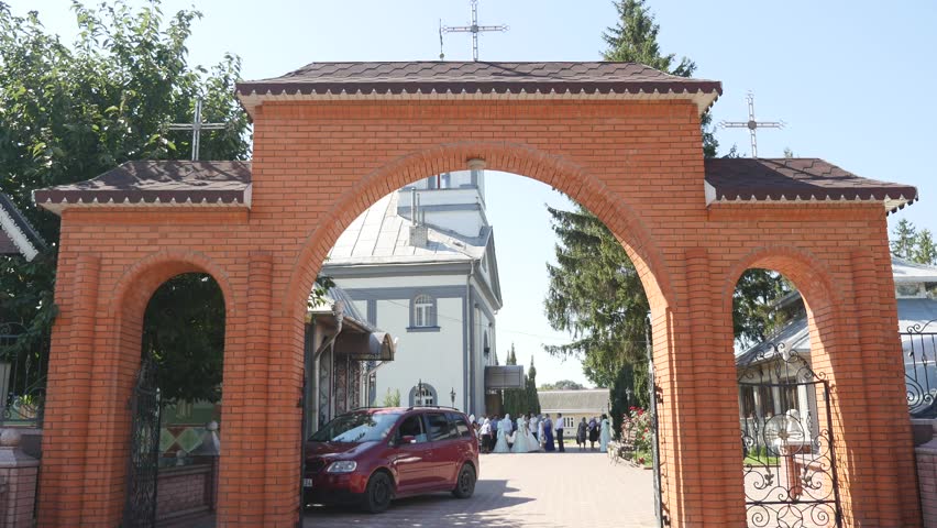 orthodox church, the entrance gate to the territory of the Orthodox church, the arch, sunny day, green trees
