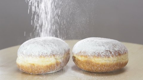 Spreading Sugar Powder On Hanukkah Doughnuts . Slow motion