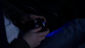 Man playing with a videogame controller in his hands