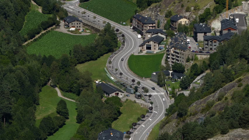 Andorra from above.Time Lapse.Fixed plane.
Aerial view of the  valley bottom of "Ordino" with green meadows and main road traffic  in motion, a summer day.