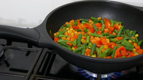 Vegetables in a pan being quenched with vegetable stock (close-up)Frying vegetables in a pan.