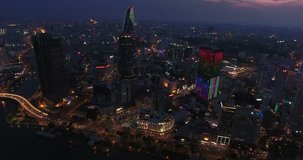 HO CHI MINH CITY, VIETNAM – MAY, 2016 : Aerial shot of central Ho Chi Minh cityscape at night with skyscrapers and Saigon river in view