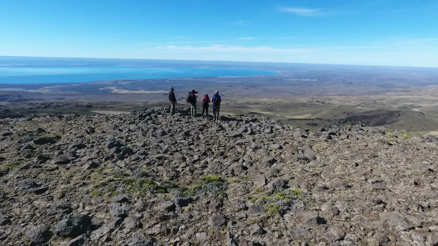 Aerial shot over hikers watching a condor 