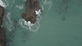 Aerial view of the beautiful rocky ocean shore at the West Coast during a cloudy winter morning. Taken in Oregon Coast, North America.