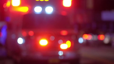 Blurred shot of ambulance with emergency lights flashing