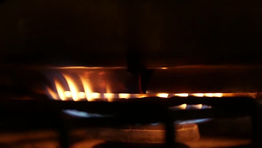 Orange and blue flames of a gas stove in the dark | Shutterstock HD Video #1006798987