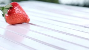 Strawberry fruits on white wooden table