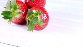Strawberry fruits on white wooden table
