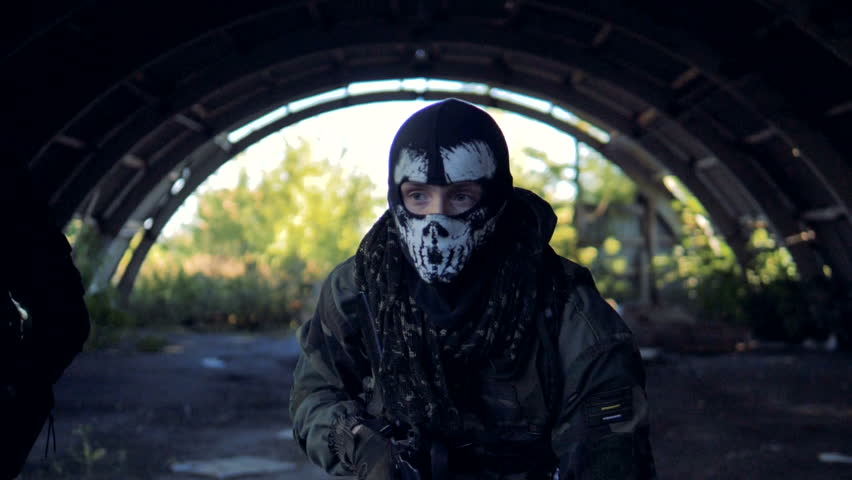 A masked fighter gives direction to his team. 