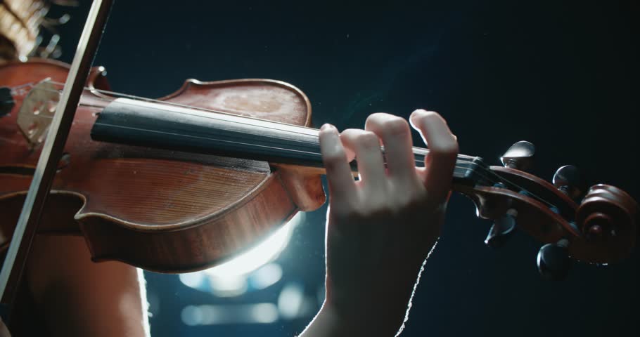 Detail shot, performance of violinist girl on stage, light, dark background | Shutterstock HD Video #1006810417