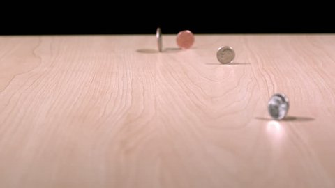 slow motion coins spinning on table
