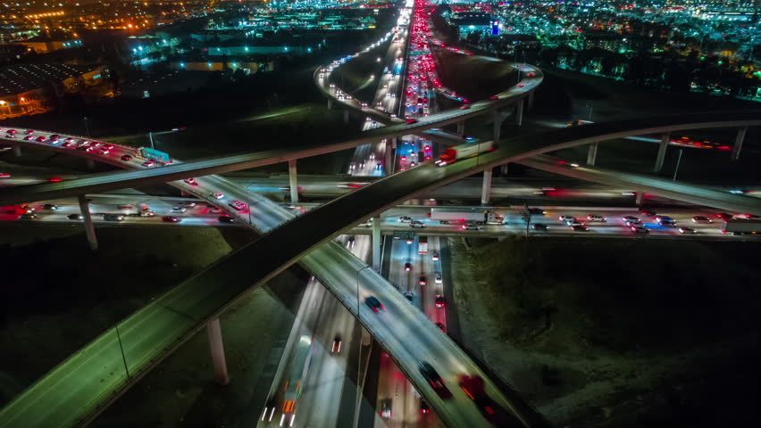 Cinematic urban aerial time lapse from above of interstate traffic causing climate change or global warming as result of CO2 emissions and pollution in our environment. Royalty-Free Stock Footage #1006816030