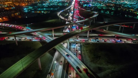 Cinematic urban aerial time lapse from above of interstate traffic causing climate change or global warming as result of CO2 emissions and pollution in our environment.