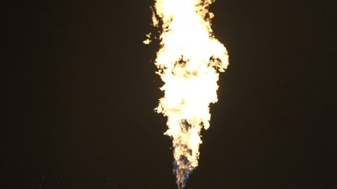 Fire ball explosion from bottom to top, fire flamethrower isolated on black background