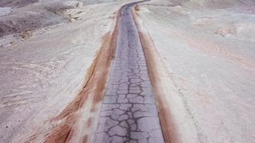 Desert road - Aerial footage of an old and remote road surrounded by dry desert landscape - Powered by Shutterstock - Get 15% off with code: PIKWIZARD15