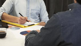Handsome businessman taking notes during business meeting - Powered by Shutterstock - Get 15% off with code: PIKWIZARD15