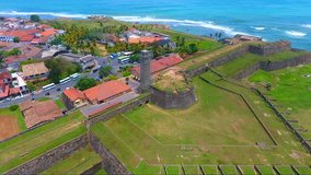 Fly around watch tower in Galle fort, Sri Lanka. Indian ocean on the background. Aerial video 