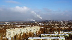 Industrial city. Cityscape. City roofs. Winter landscape. Emissions of pollutants. Air pollution. 4k time lapse. No flicker, no birds, retouched video.
