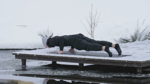 A man is meditating in nature in the winter. Yoga.
