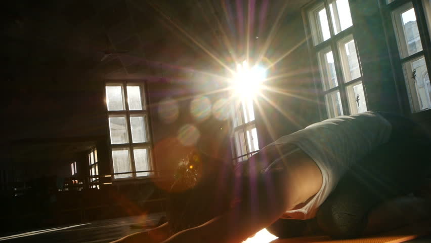 a young woman, has a healthy lifestyle in the fitness studio with the sun shining