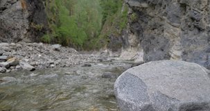 Beautiful water in a mountain river in slow motion video. Shooting speed 24fps. Live shooting of the most beautiful nature river mountain water. The camera is not static.